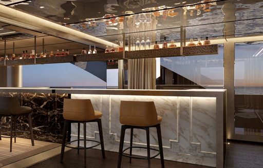 Wet bar and stools in the interiors of charter yacht RAJA² 