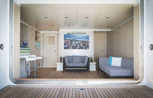 Beach club with seating onboard superyacht charter TITANIA