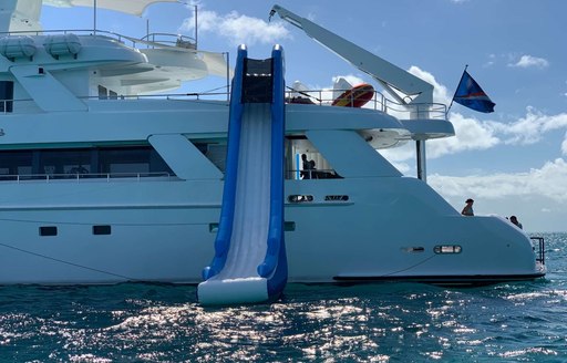 gigantic slide on the side of lucury charter yacht island heiress that slides into the ocean