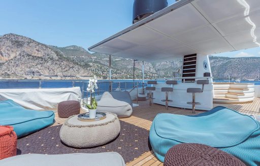 Charter yacht AWAY sun deck with seating and wet bar