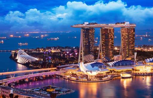 city of singapore at night, towering builds