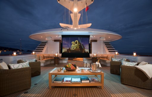 A projector screen shows the 20th century Fox logo on board the sundeck of a superyacht