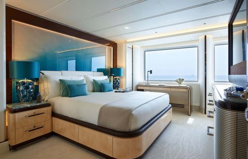 Double guest cabin onboard superyacht charter EXCELLENCE with a central double berth and large windows aft