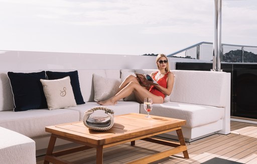 superyacht samurai woman sitting in superyacht samurai's lounging area