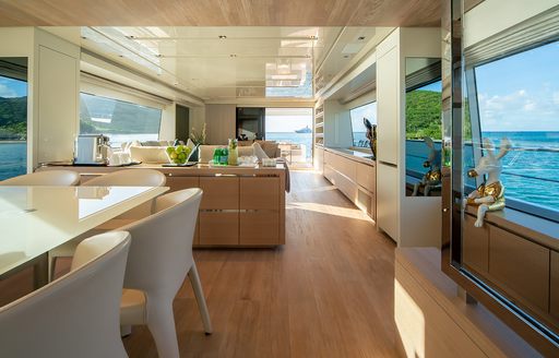Charter yacht SQUALO interiors, with dining table in foreground