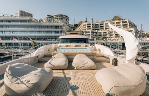 Foredeck onboard charter yacht ANDIAMO with sun pads and cushioned seating