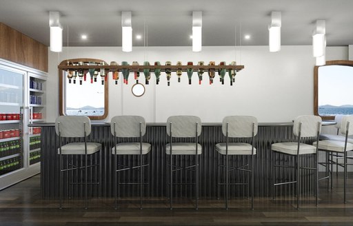 sleek bar with stools in the main salon of charter yacht CORSARIO 