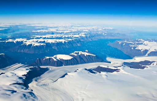 Aerial view looking over snowy rock formations in Greenland