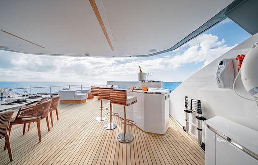 Charter yacht PROPOSITION exteriors with wet bar and stools