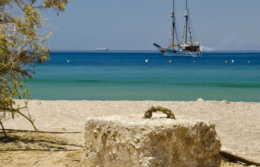 Sandy beach and a galleon on the sea