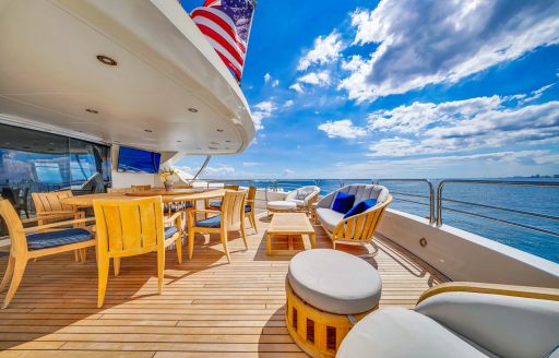 Charter yacht NATURAL 9 exterior deck space with dining area