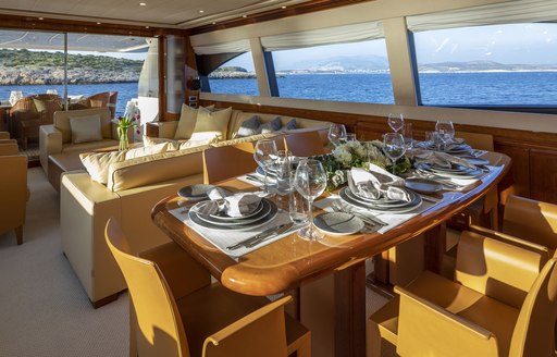 dining table set for dinner in the main salon of charter yacht ASTARTE 