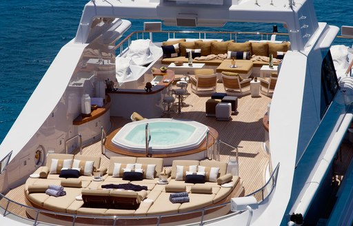 sun pads, Jacuzzi, bar and large seating area on sundeck of superyacht Helios