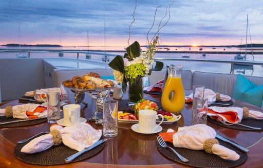 breakfast is served as the sun rises on aft upper deck of motor yacht RHINO 