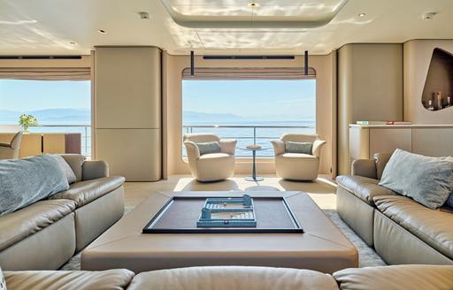 Charter yacht VOLANTE main salon lounge area with cream seating