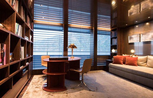 Elegant office area on superyacht SAVANNAH, with ambient lighting and sofa visible