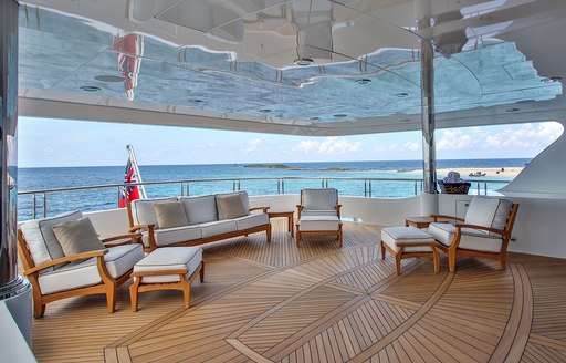 Aft deck with social seating and al fresco dining aboard superyacht REBEL