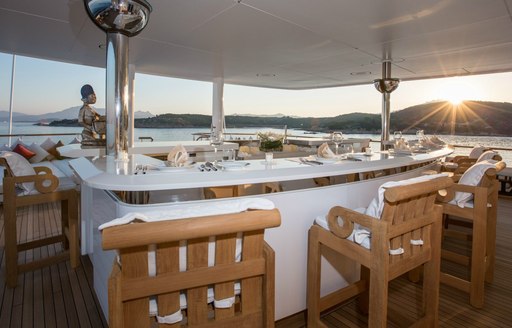 alfresco bar surrounded by 12 bar stools on top deck of superyacht Coral Ocean