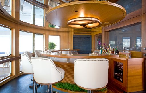 bridge deck bar with white bar stools and waterfall feature aboard charter yacht ‘Indian Empress’ 