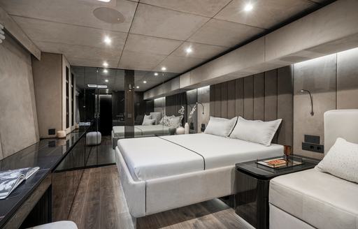 Master cabin onboard S/Y GREY B, central berth facing port with large mirrors in background