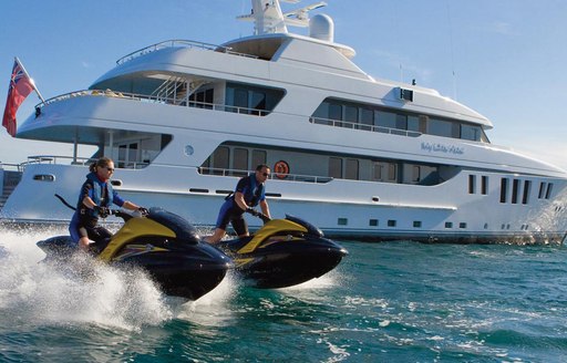 My Little Violet yacht at anchor while charter guests play with toys in the water alongside