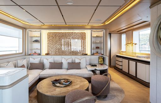 Charter yacht HAZE² interior seating area with plush cream sofa