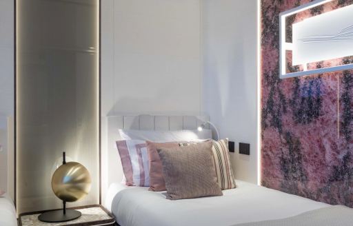 Guest cabin with purple hues onboard charter yacht ACQUA CHIARA