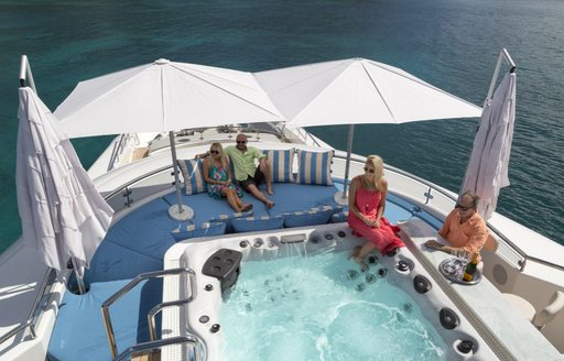 Charter guests sitting around jacuzzi spa pool in Belize