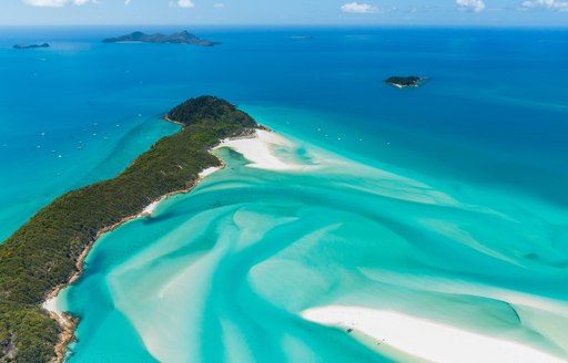 Aerial shot of the Whitsunday Islands, white sandy beaches and green blue sea