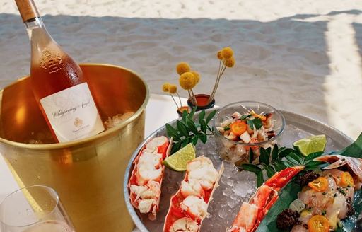 Lobster dish with wine bucket at Lucca Beach