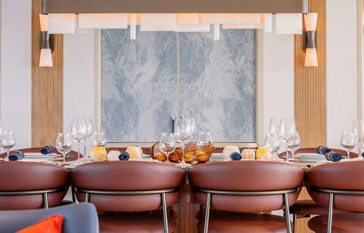 Charter yacht AD ASTRA dining table and brown seats