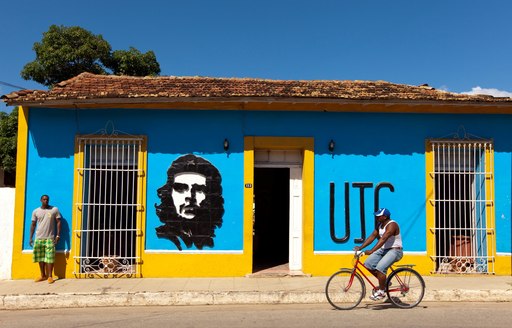 cyclist rides along street in Cuban coastal town