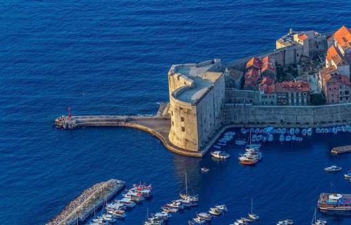 Dubrovnik old city defense walls details. St. John fortress at the harbor entrance. 