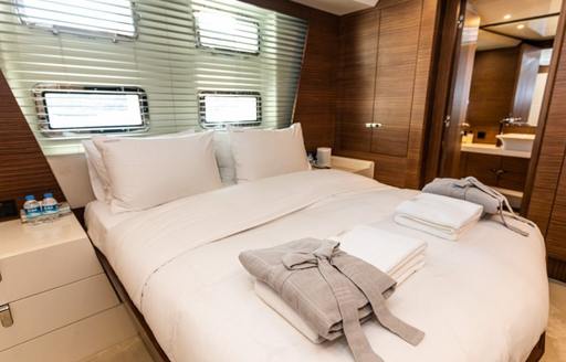 Double guest cabin with central berth and arranged bathrobes onboard charter yacht ZEEMAR