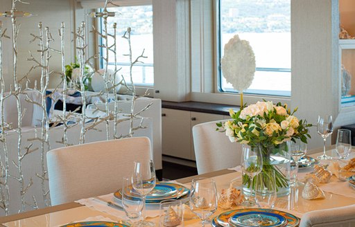 details on luxury yacht spirit, table setting and silver sculpture