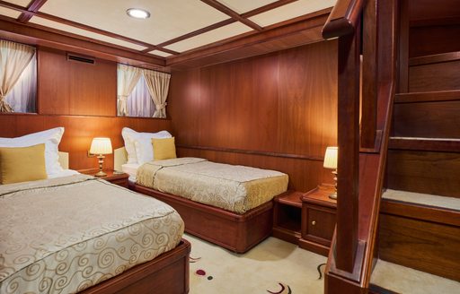 Twin cabin onboard charter yacht SEAGULL II with two single berths and stairs in the foreground