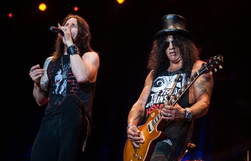 Singer and bassist of Guns N Roses performing on stage 