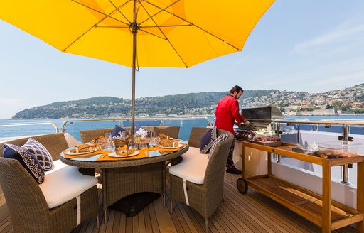 chef prepares a barbecue lunch on the sundeck of luxury yacht BINA 