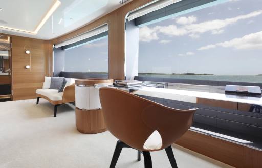 Bureau and seat facing large window onboard charter yacht A SALT WEAPON