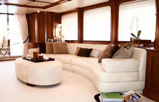 curved sofa in the main salon aboard charter yacht BRUNELLO