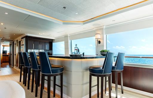 Charter yacht ALTA interior wet bar with several stools