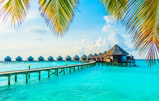 Blue sea in the Maldives, bungalows above the water