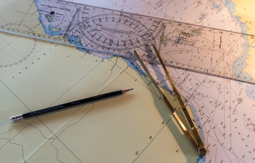 maps and charts on board motor yacht over the rainbow