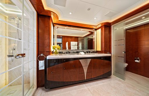 Overview of the ensuite for the master cabin onboard charter yacht AMARYLLIS with a large sink unit and shower cubicle