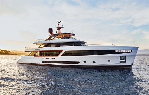 Charter yacht ALLURIA at anchor, surrounded by sea at sunset