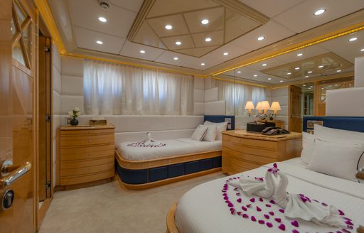 Twin guest cabin with two single berths and a large window onboard charter yacht LADY AZUL