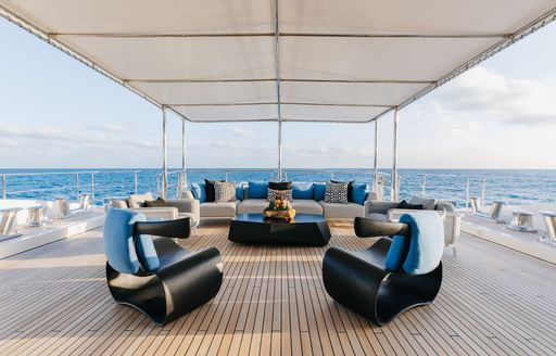 Exterior seating with large armchairs onboard charter yacht ETERNITY
