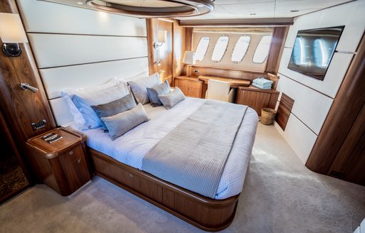 owners suite on luxury superyacht chess, with large double bed and wide windows