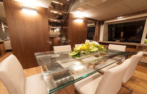Charter yacht SEATALY formal dining area with white seating