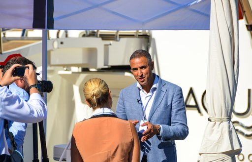 man discusses matters with woman during monaco yacht show 